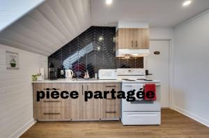 a kitchen with a white appliance in a room at Chambre 304 de l'hôtel Victoria confortable et moderne in Saint-Pascal +14 photos