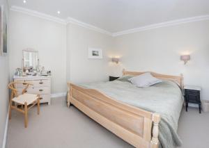 a bedroom with a bed and a table and a chair at St Margarets Mews in Durham