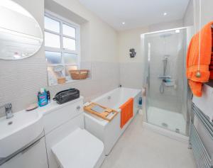 a bathroom with a tub and a sink and a shower at St Margarets Mews in Durham