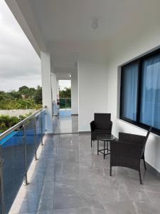 a hallway with two chairs and a table in a building at Hotel Rincón Samaná in Las Galeras