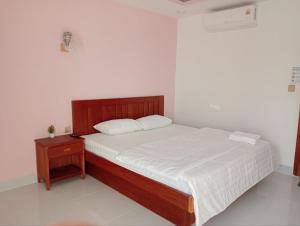 a bedroom with a bed and a nightstand with a white mattress at Good Dream Guest Home in Phumĭ Toch