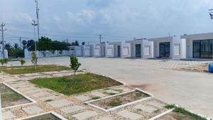 a row of white buildings in a parking lot at Good Dream Guest Home in Phumĭ Toch