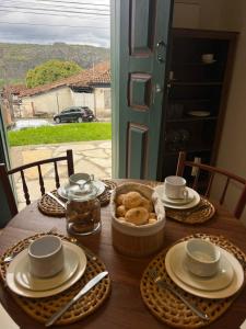 a wooden table with a bowl of pastries on it at Loft Macau in Diamantina