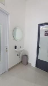 a white bathroom with a sink and a mirror at Sukabumi Villa Mochi Private Jacuzzi in Sukabumi +22 photos