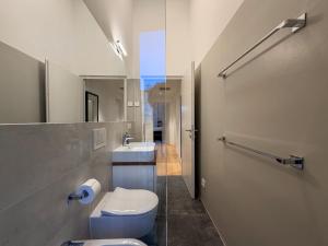 a bathroom with a toilet and a sink at Design Apartment Archea Terrazza sul Lago Maggiore in Laveno-Mombello +50 photos