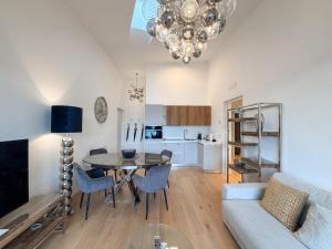 a living room with a table and a couch at Design Apartment Archea Terrazza sul Lago Maggiore in Laveno-Mombello