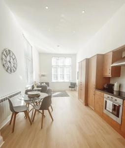 a kitchen and a living room with a table and chairs at 7 The Cathedrals in Durham