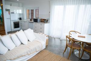 a living room with a white couch and a table at El Parche Bilinga Beachside in Gold Coast