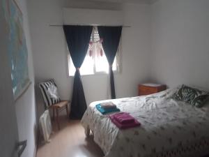 a bedroom with a bed and a window at El Jacaranda in Carmen de Patagones