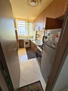 a small kitchen with a refrigerator and a stove at Swiss Home in Agadir