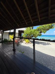 a view of the beach from the deck of a resort at Chez Aroro Beach House in Avatoru