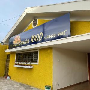 a yellow building with a sign on the side of it at Morada 1000 - Pousada in Frutal +7 photos