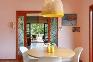 a dining room with a wooden table and chairs at Thirroul Beach Apartments in Thirroul