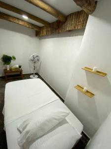 a room with a white toilet with a fan at Coco Cabaña Barú in Cartagena de Indias