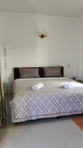 a bedroom with a bed with two towels on it at Ban Pai Khlung Resort in Chanthaburi