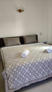 a bed with two pillows on top of it at Ban Pai Khlung Resort in Chanthaburi