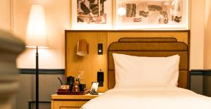 a bedroom with a bed and a night stand with a lamp at Union Hotel in Toronto