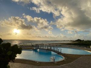 a swimming pool with a view of the ocean at Sunset View & Ocean Breeze in Cul de Sac