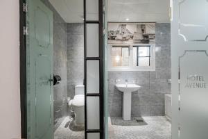 a bathroom with a toilet and a sink at Hotel Avenue in Tansa-gol +52 photos