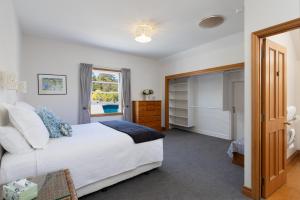 a bedroom with a bed and a window at City Apartment South Street in Nelson