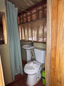 a bathroom with a toilet and a sink at Tyler's place in Coco +91 photos