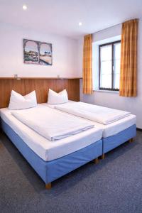 a bedroom with two large beds in a room at Hotel Wendelstein München City in Munich +13 photos