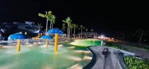 a water slide at a resort at night at V3L05-Sonasea Vân Đồn in Thâm Câu +5 photos
