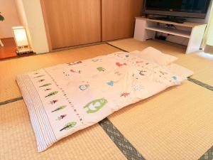 a bed on the floor in a living room at ura tomari in Okayama +38 photos