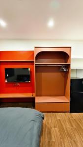 a bedroom with an orange wall and a bed at 4Chan Phúc Đồng Apartment in Hanoi