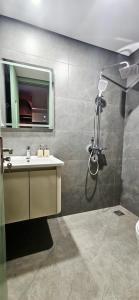 a bathroom with a shower and a sink and a mirror at 4Chan Phúc Đồng Apartment in Hanoi