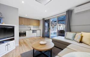 a living room with a couch and a table at Large Pet Friendly Island Escape in Newhaven