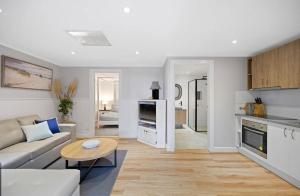a living room with a couch and a table at Large Pet Friendly Island Escape in Newhaven +5 photos