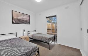 a bedroom with two beds and a window at Large Pet Friendly Island Escape in Newhaven