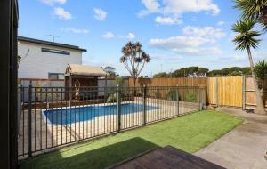 a fence around a swimming pool in a yard at Large Pet Friendly Island Escape in Newhaven