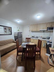 a kitchen and living room with a table and chairs at Sanremo Oasis Staycation in Cebu City