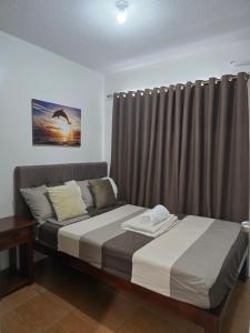 a bedroom with two beds and a curtain at Sanremo Oasis Staycation in Cebu City +20 photos