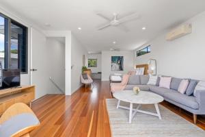 a living room with a couch and a table at Grottamare in Lennox Head
