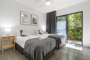 a bedroom with two beds and a large window at Grottamare in Lennox Head +30 photos