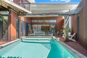 an indoor swimming pool in a house with a patio at Grottamare in Lennox Head