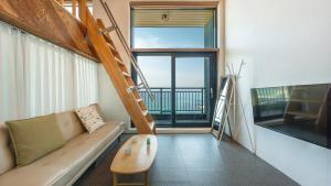 a living room with a couch and a large window at Capella Oceanview Spa Resort – Goseong in Goseong