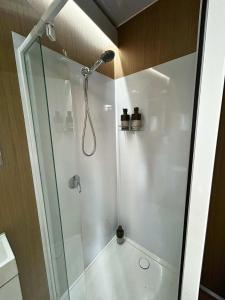 a shower with a glass door in a bathroom at Mirror Reflections 2 by Tiny Away in Tamborine