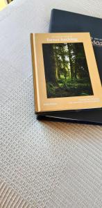 a book sitting on top of a table at Mirror Reflections 2 by Tiny Away in Tamborine +2 photos