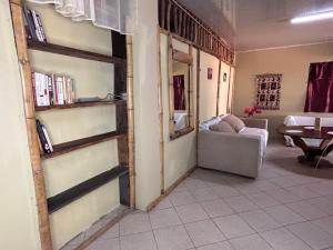 a living room with a book shelf and a couch at Tyler's place in Coco