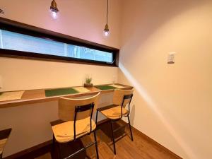 a dining room with a table and two chairs at ura Kyunoju in Okayama