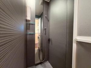 a shower in a bathroom with a glass door at ura Kyunoju in Okayama +21 photos