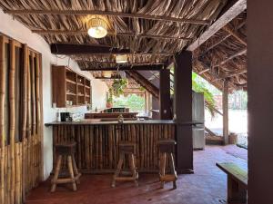 a kitchen with two stools and a bar in a room at Tyler's place in Coco