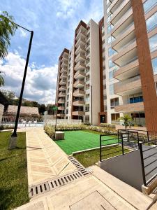 a large apartment complex with a lawn in front of a building at Apartamento en Villeta in Villeta