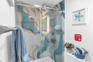a shower with a glass door in a bathroom at The Oasis Signature in Miami