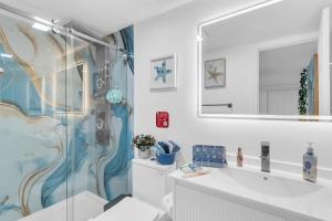 a bathroom with a shower and a sink and a mirror at The Oasis Signature in Miami +21 photos