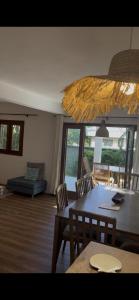 a living room with a table and chairs and a couch at Thelazycoco in Blue Bay